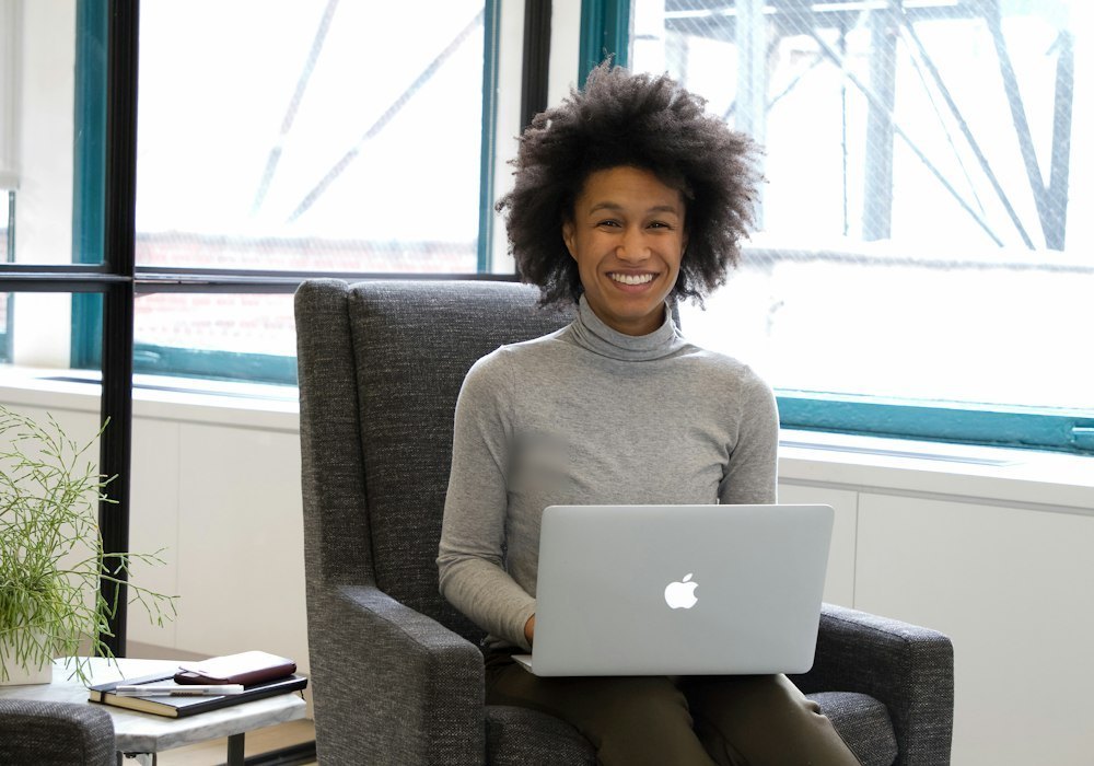 Smiling woman with a laptop